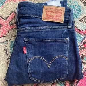 Levi’s 711 skinny jeans with two rips in the knees